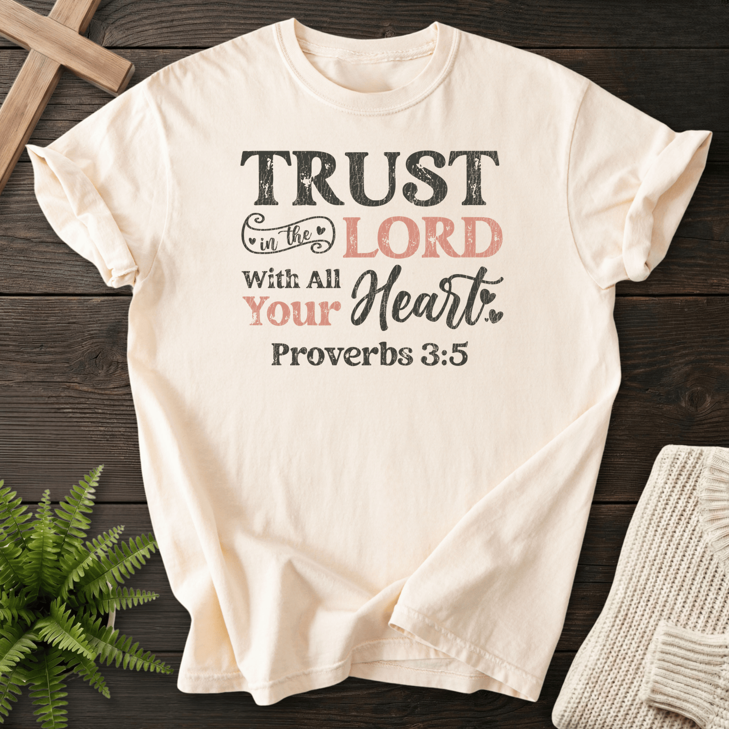 Ivory Scripture shirt with bold layered Trust in the Lord With All Your Heart lettering and heart accents, inspired by Proverbs 3:5.