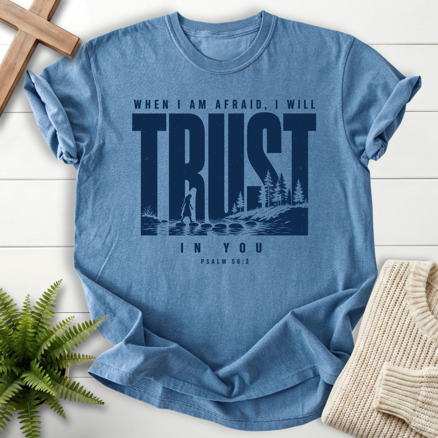 Flatlay of a Blue Jean faith-based tee with "Trust When I am Afraid T-Shirt" Psalm 56:3.