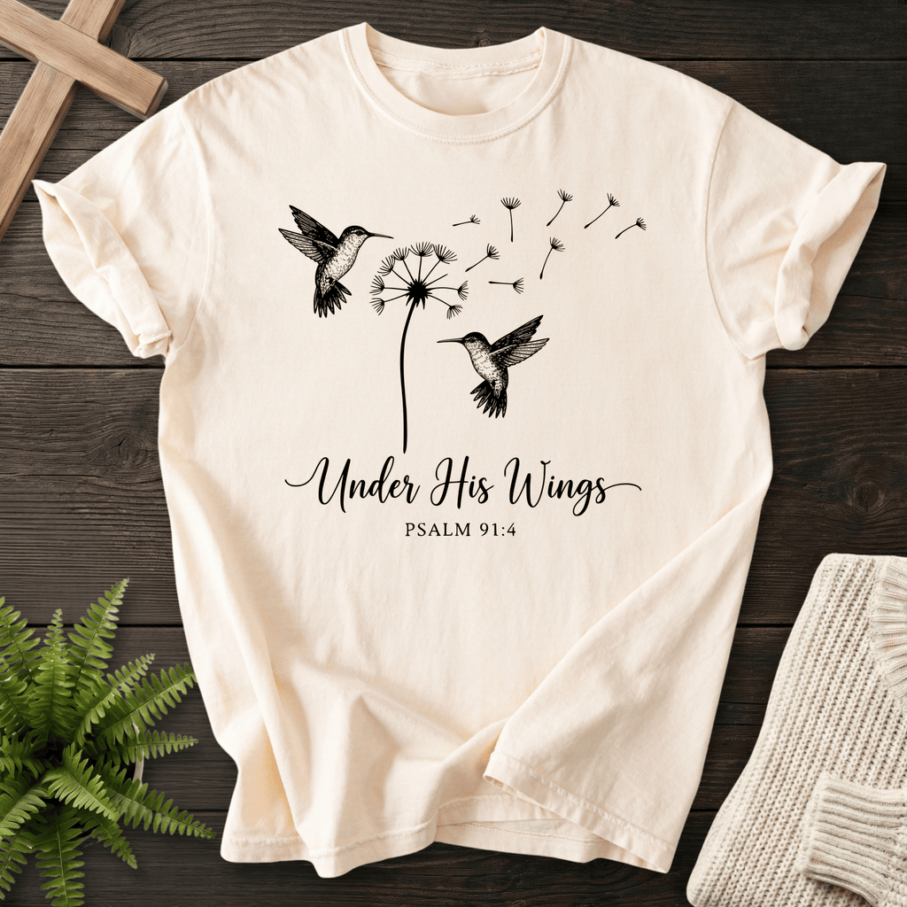 Ivory Christian t-shirt for women with hummingbirds and dandelion illustration and Under His Wings text, inspired by Psalm 91:4.