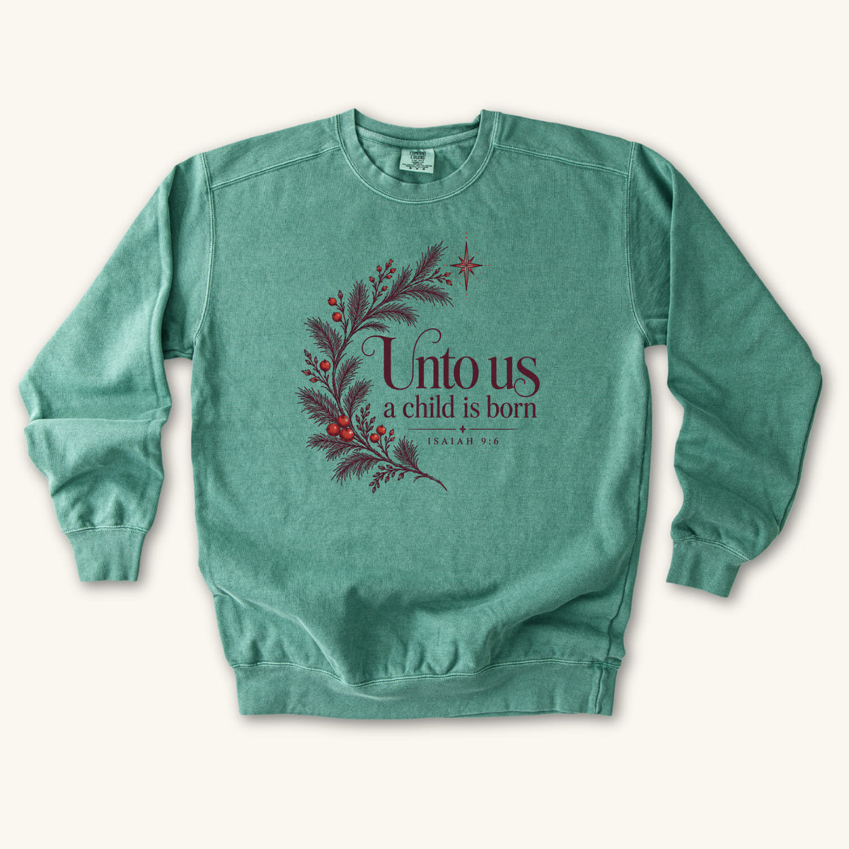 Light Green Christian Christmas sweatshirt with Unto Us a Child Is Born lettering, evergreen branches, red berries, a star and Isaiah 9:6.