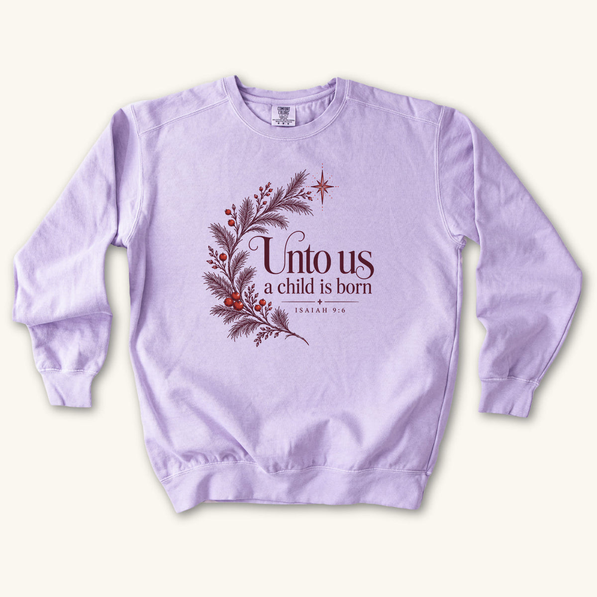 Orchid Christian Christmas sweatshirt with Unto Us a Child Is Born lettering, evergreen branches, red berries, a star and Isaiah 9:6.
