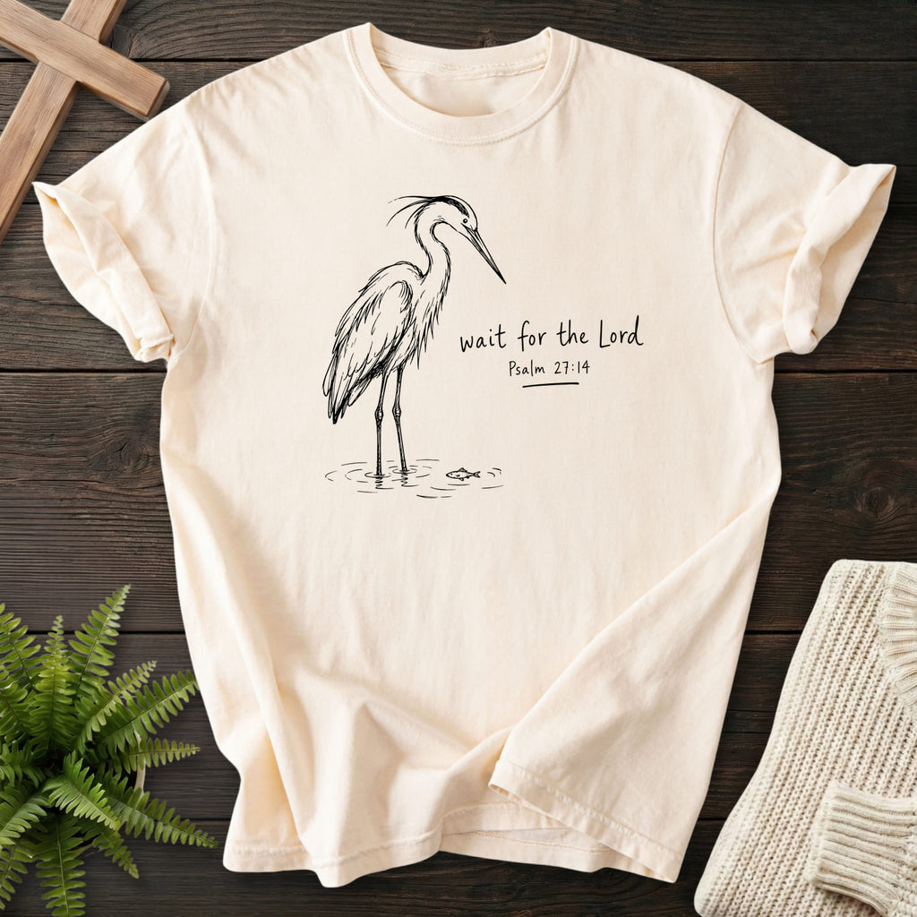 Flatlay of an Ivory faith-based tee with "Wait for the Lord Bird T-Shirt" Psalm 27:14.