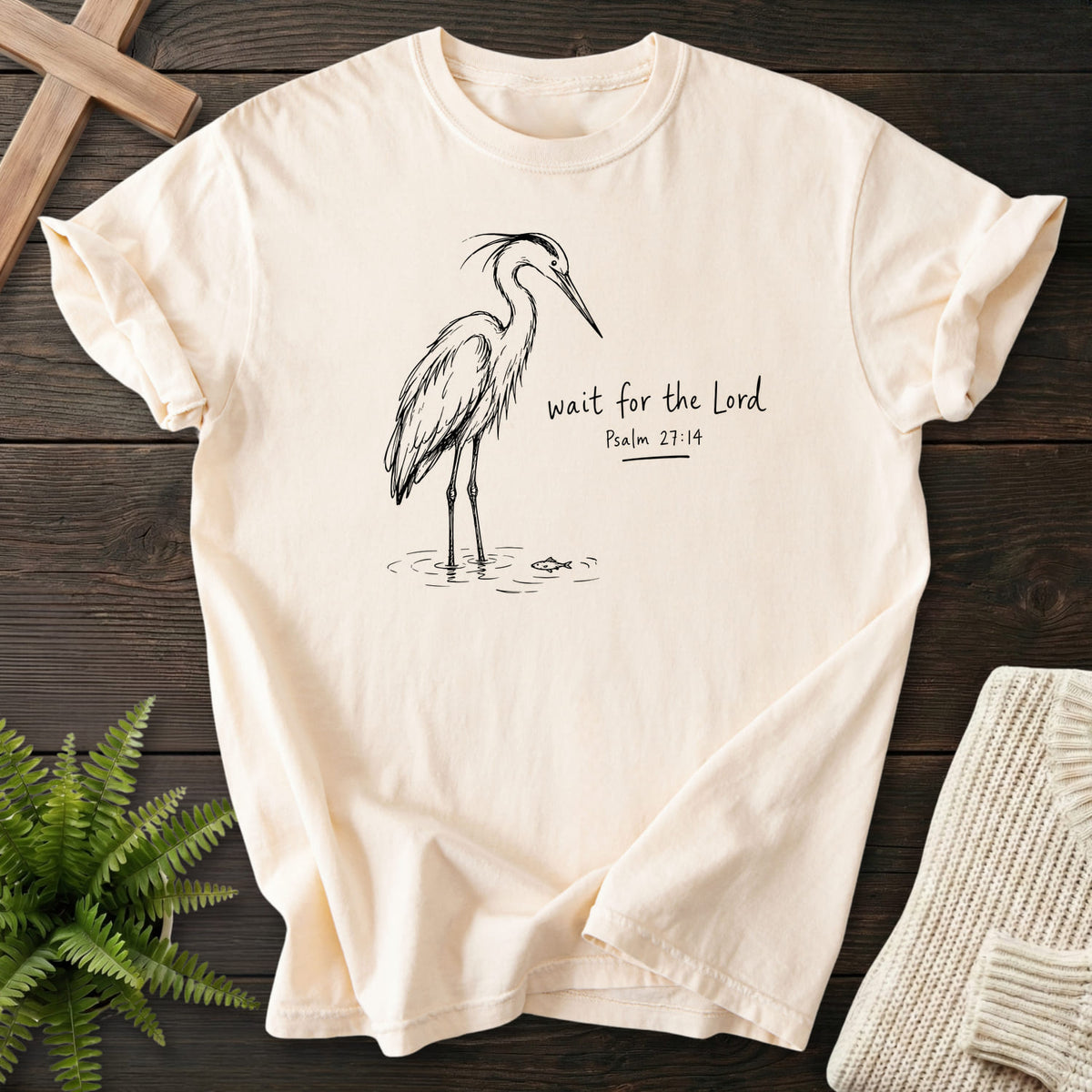 Flatlay of an Ivory faith-based tee with "Wait for the Lord Bird T-Shirt" Psalm 27:14.