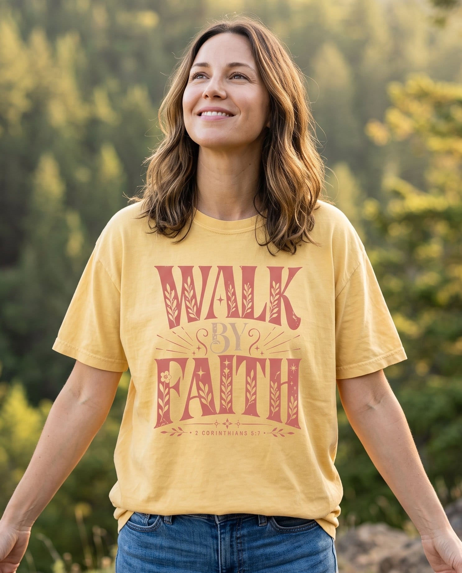 Walk By Faith 2 Corinthians 5:7 – Butter women's Christian tee, lifestyle photo in nature trail – Bold vintage-style dusty rose display lettering WALK BY FAITH with flo – 2 Corinthians 5:7 – She Wears Faith