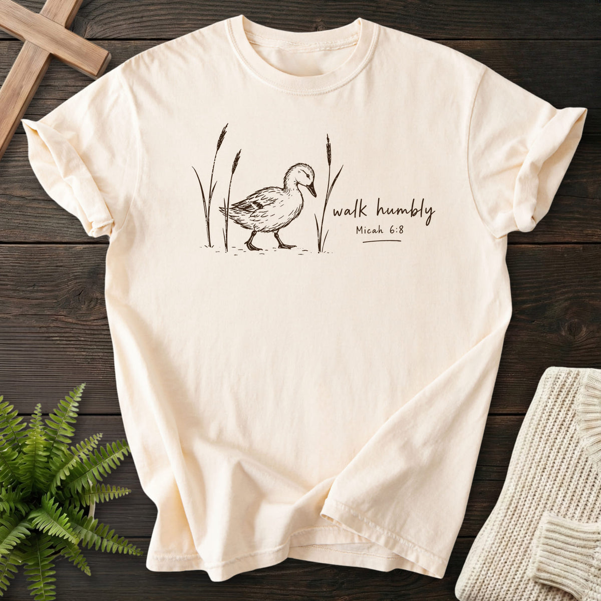 Flatlay of an Ivory Christian graphic tee with "Walk Humbly Duck Micah 6:8 T-Shirt" Micah 6:8.