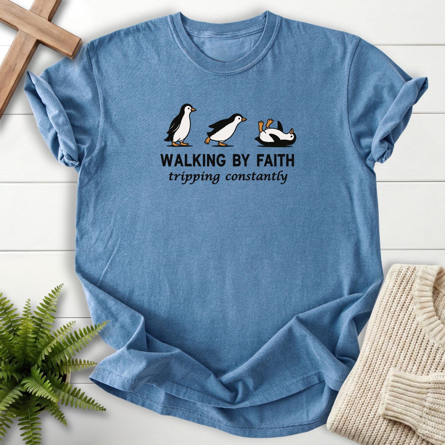 Flat lay of a Blue Jean Christian t-shirt for women featuring "Walking BY Faith T-Shirt" design.