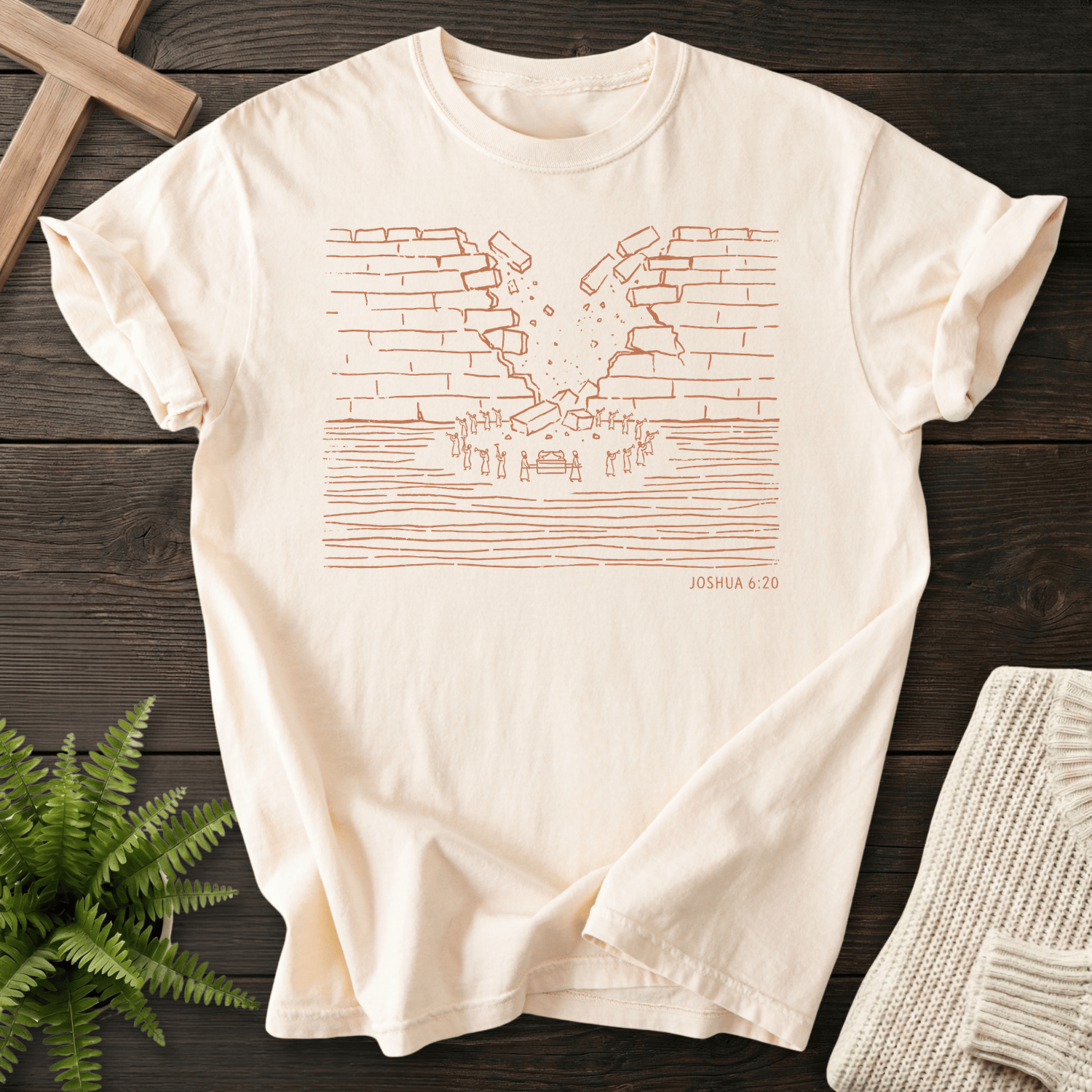 Ivory faith-based tee with a minimal Walls of Jericho illustration, inspired by Joshua 6:20.