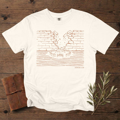 Comfort Colors 1717 ivory Christian women tee showcasing a minimalist wall-of-Jericho artwork based on Joshua 6:20, drawn in warm line-art. A stylish scripture-rooted T-shirt for US faith wear, perfect for Christian women who enjoy subtle Bible-story designs.