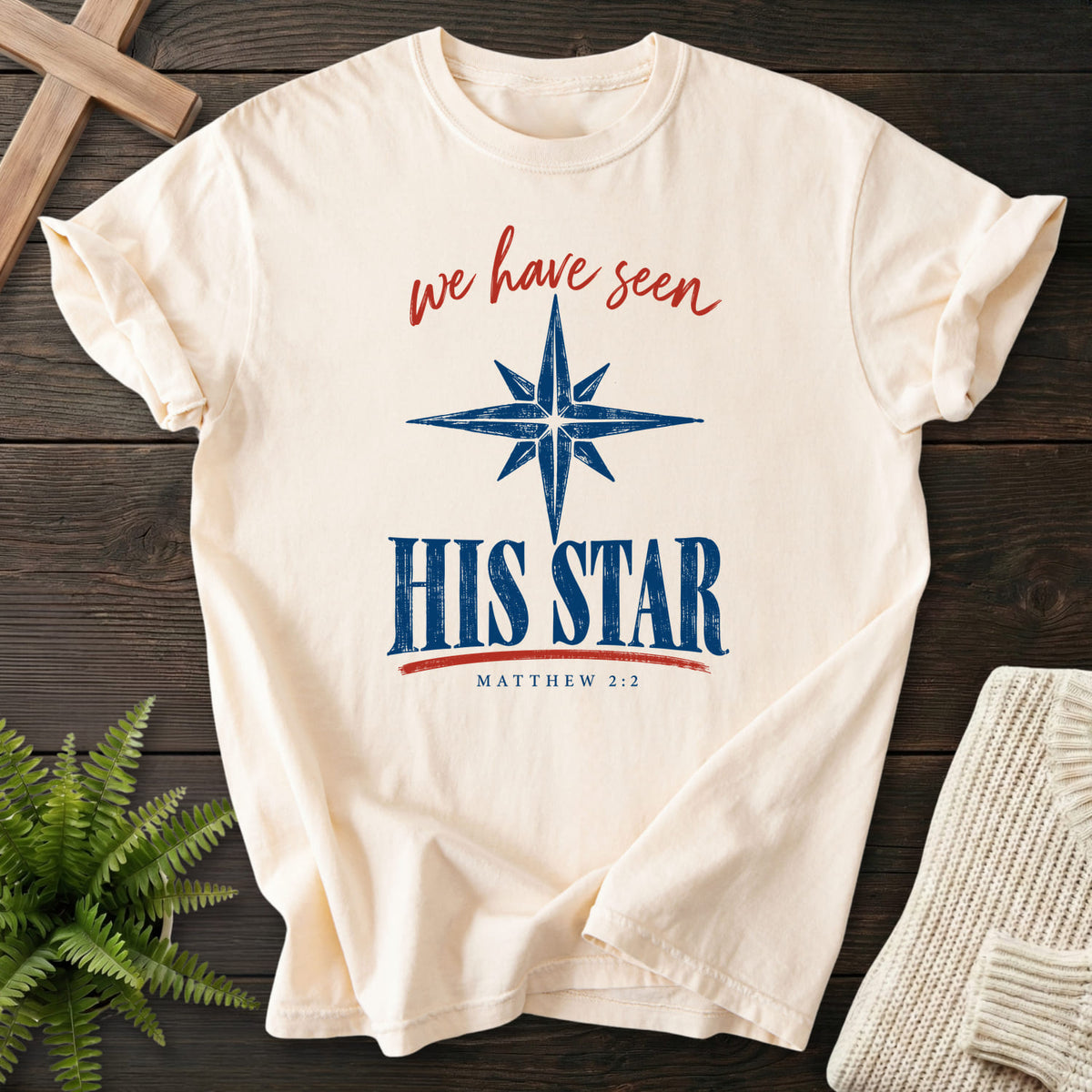Flat lay of an Ivory Comfort Colors 1717 Christian t-shirt for women featuring script typography with "We Have Seen His Star T-Shirt" Its Matthew 2:2.