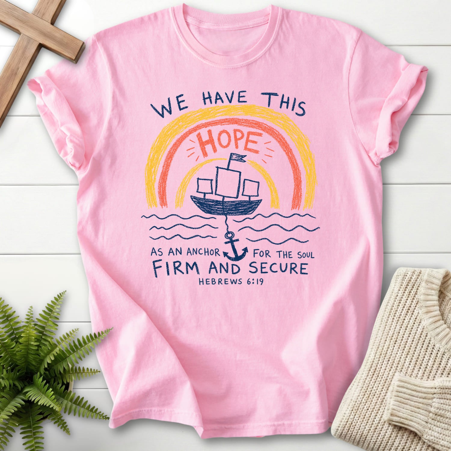 Flatlay of a Blossom Comfort Colors 1717 Christian t-shirt for women with "WE HAYE THIS T-Shirt" Hebrews 6:19 From Printify.
