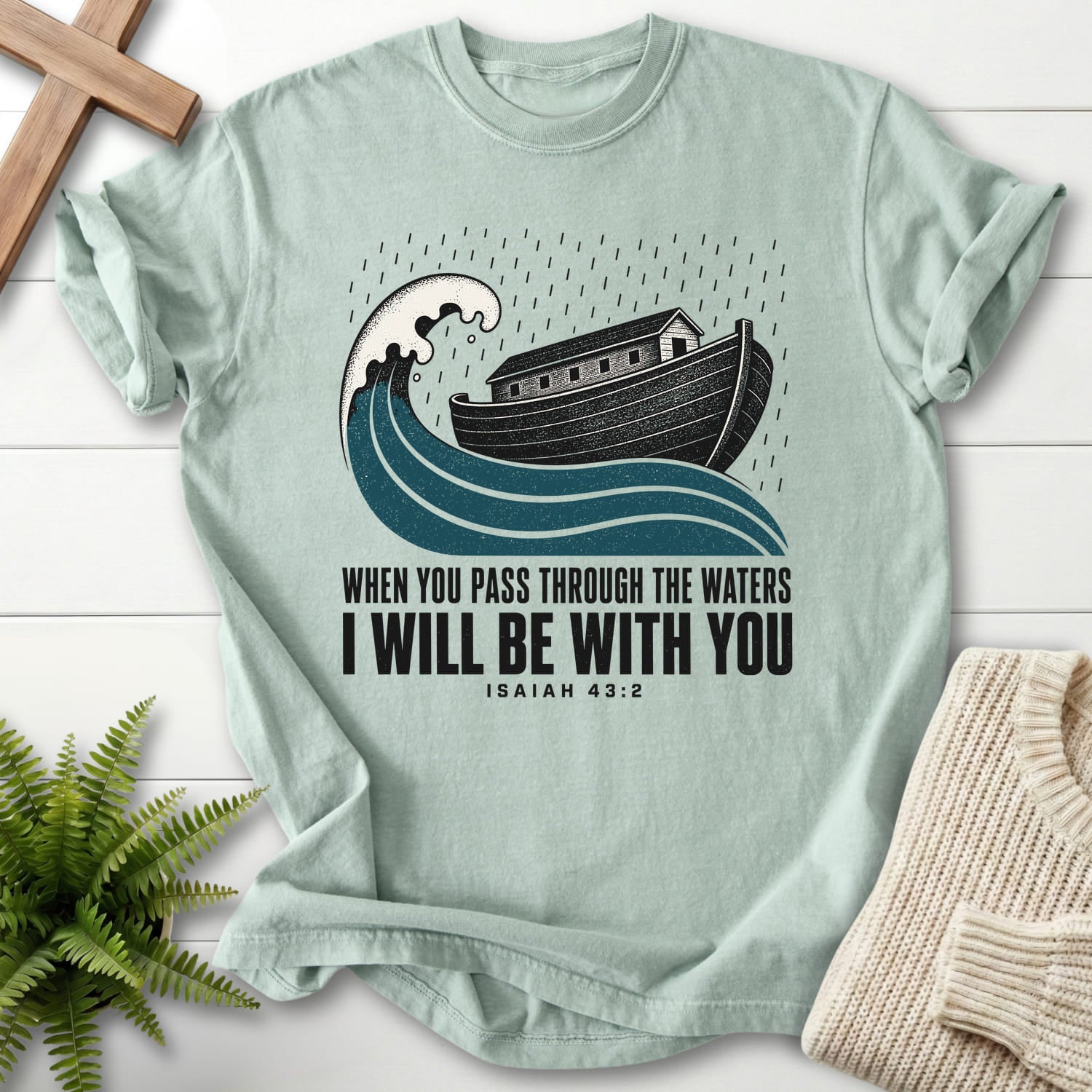Flat lay of a Bay Comfort Colors 1717 garment-dyed Christian tee featuring "When You Pass Through The Waters T-Shirt" Isaiah 43:2 From Printify.