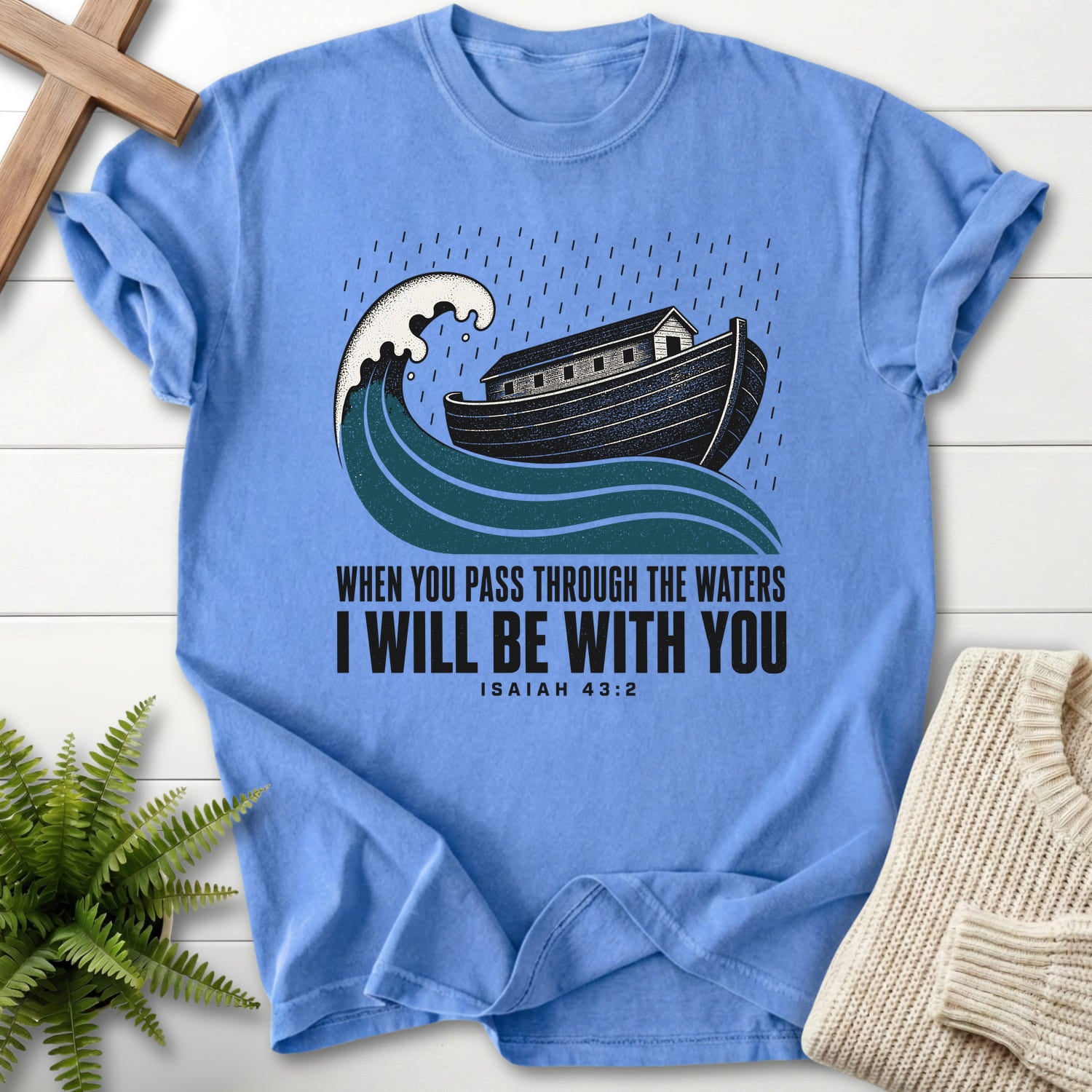 Flat lay of a Mystic Blue faith-based tee featuring "When You Pass Through The Waters T-Shirt" Isaiah 43:2.