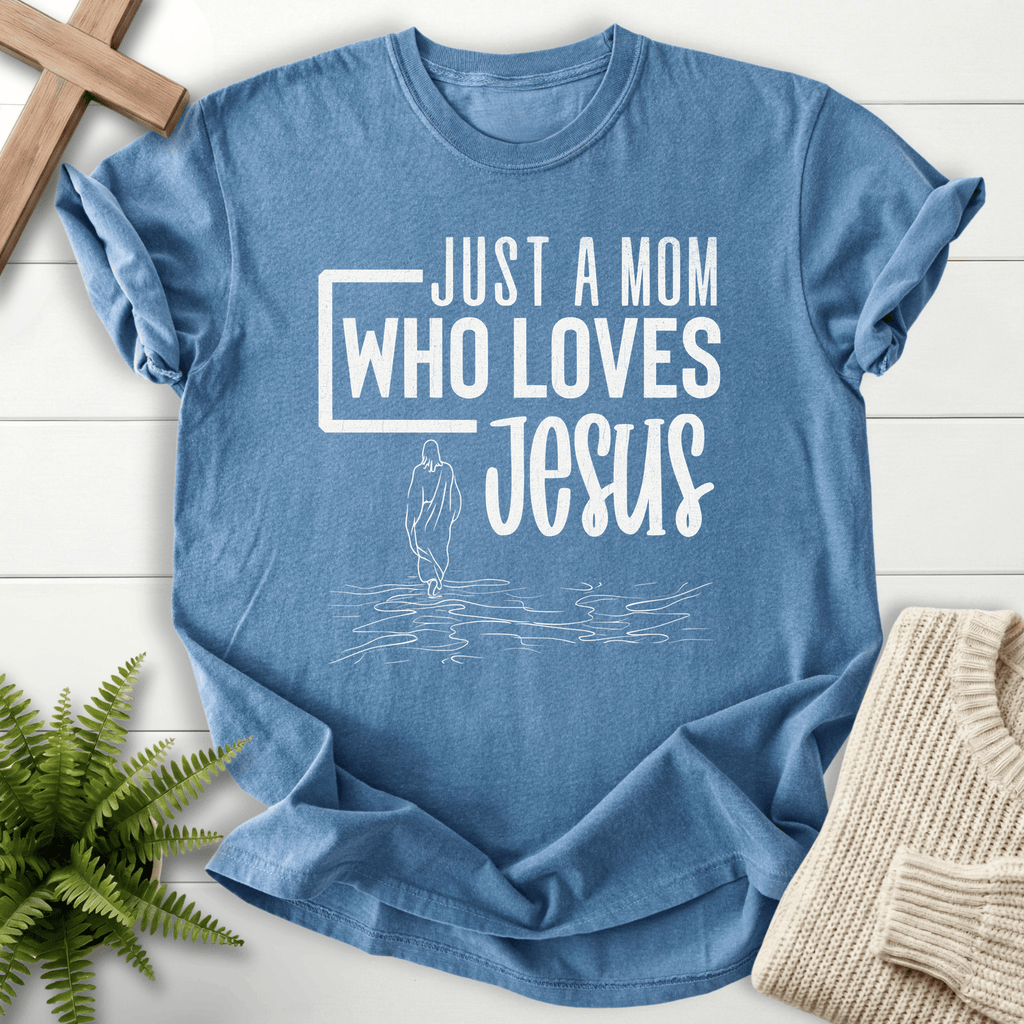 Blue Jean women's Christian t-shirt with bold 'Just a Mom Who Loves Jesus' lettering and line-art silhouette.