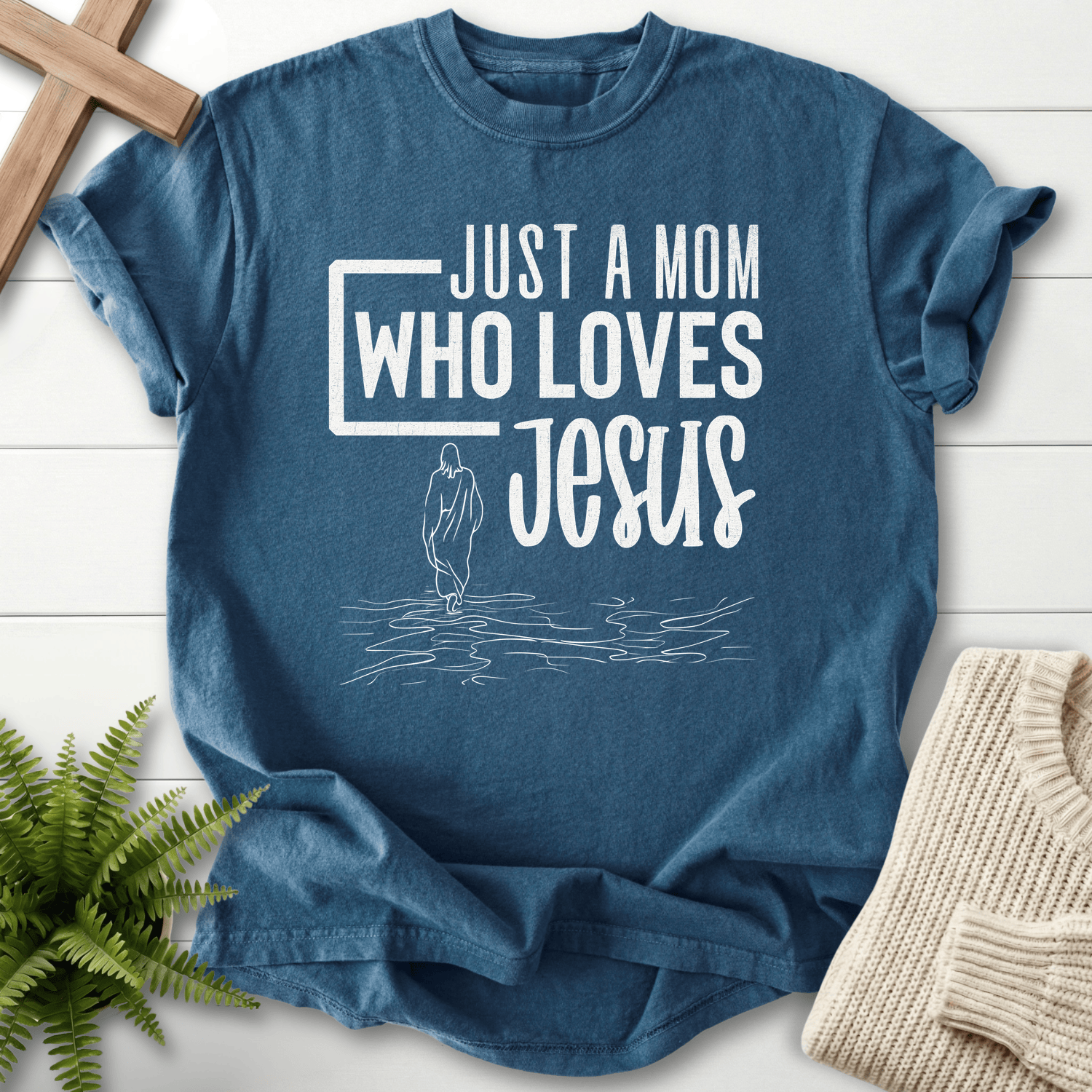 Midnight women's Christian t-shirt with 'Just a Mom Who Loves Jesus' walking-on-water silhouette.