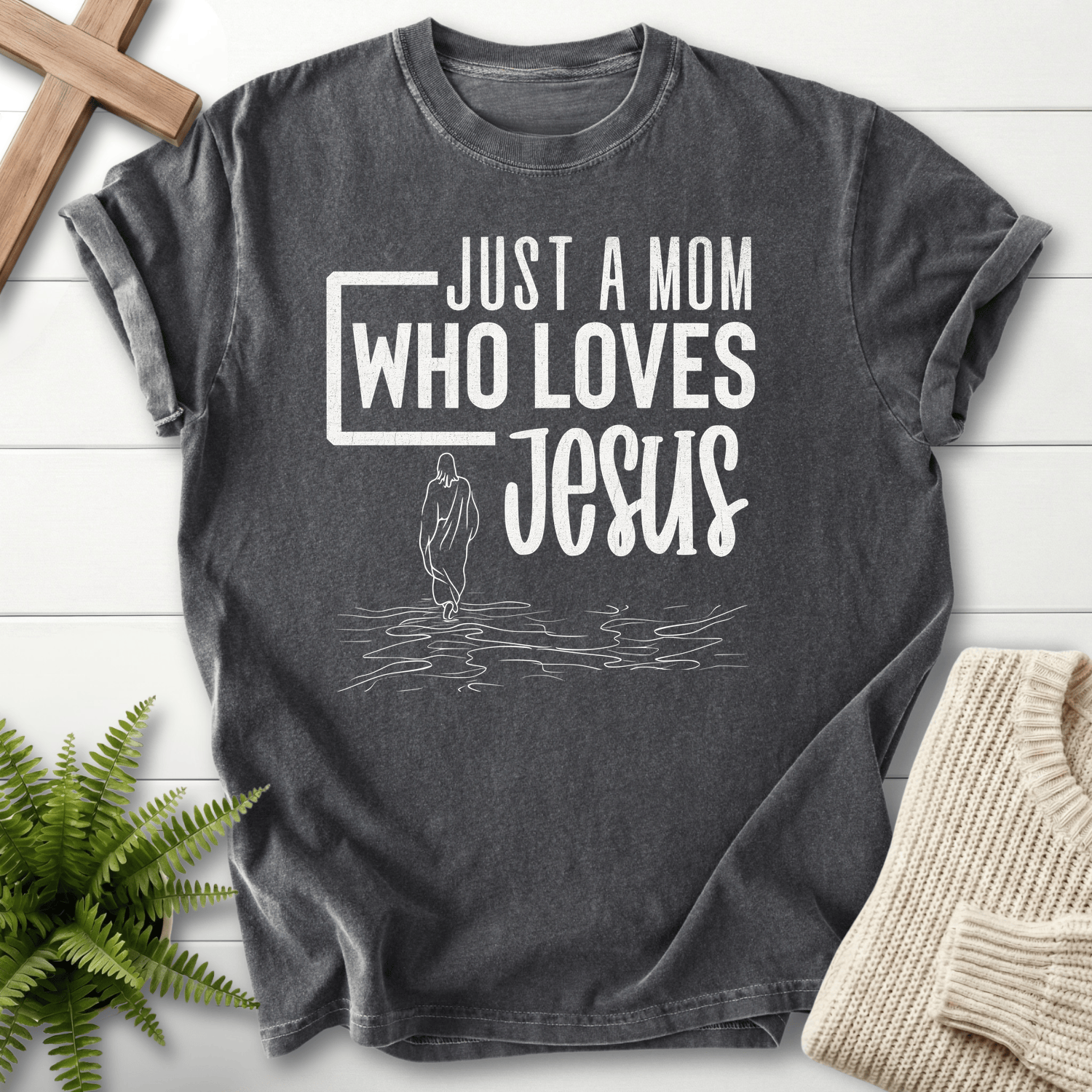 Pepper grey women's faith t-shirt with 'Just a Mom Who Loves Jesus' bold text and line-art figure.