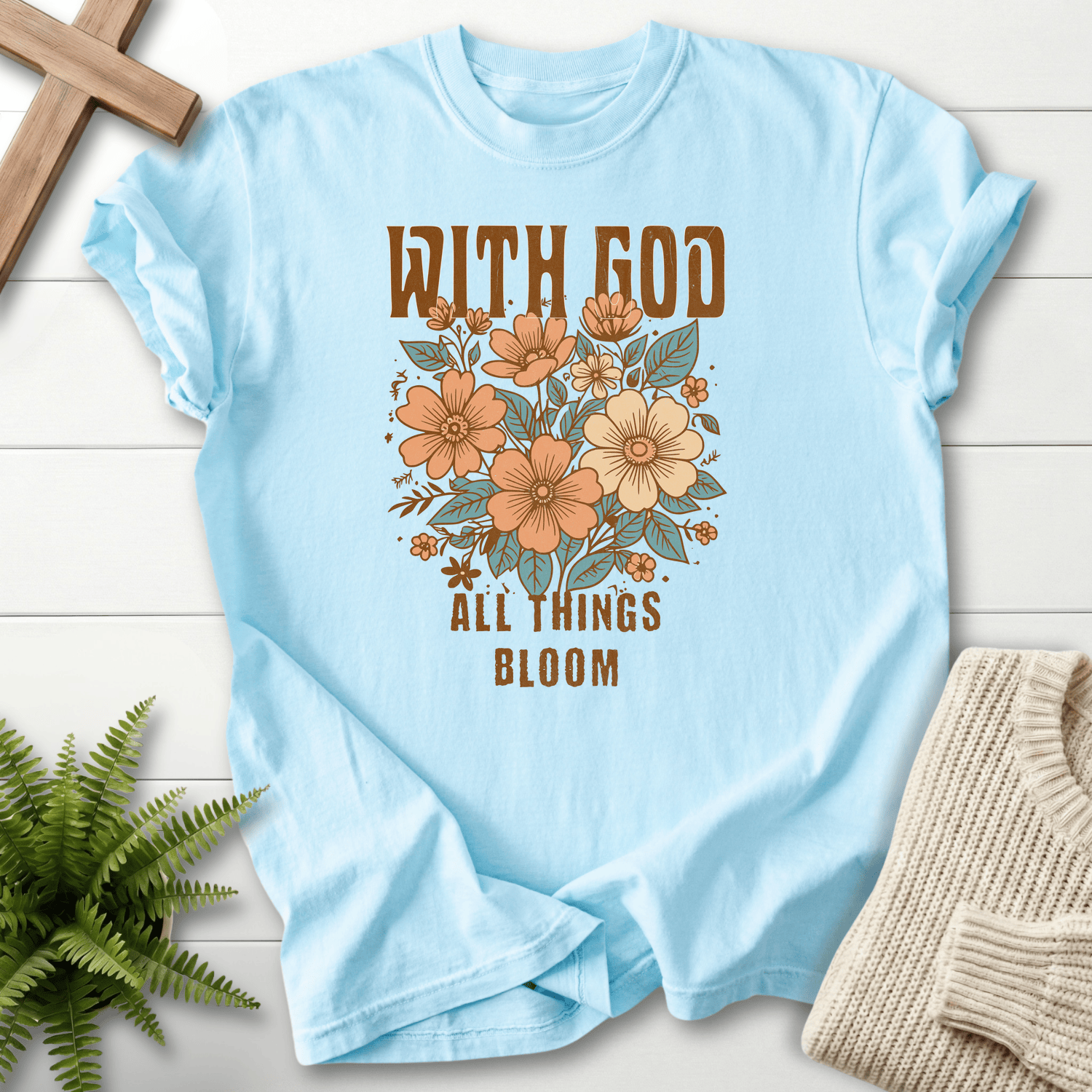 Chambray Bible verse tee with With God All Things Bloom and an earthy floral graphic, Comfort Colors 1717.