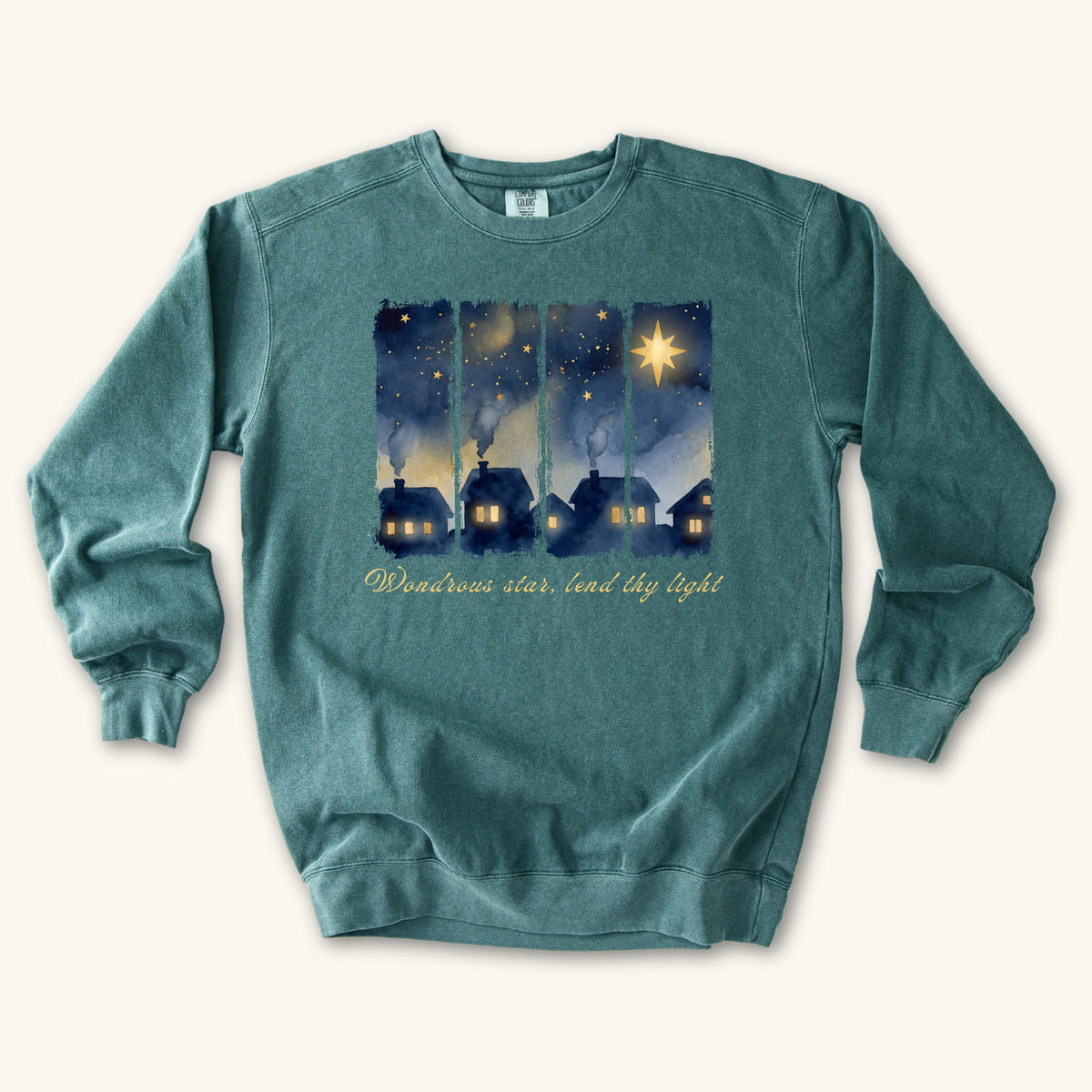 Blue Spruce Christian Christmas sweatshirt with a painted village at night, glowing windows, a big golden star and Wondrous star, lend thy light in script.