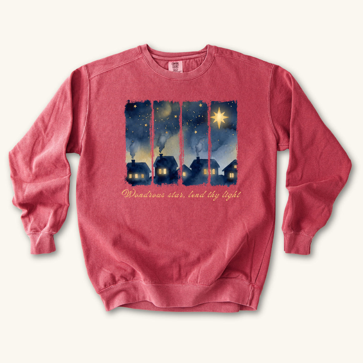 Crimson Christian Christmas sweatshirt with a painted village at night, glowing windows, a big golden star and Wondrous star, lend thy light in script.