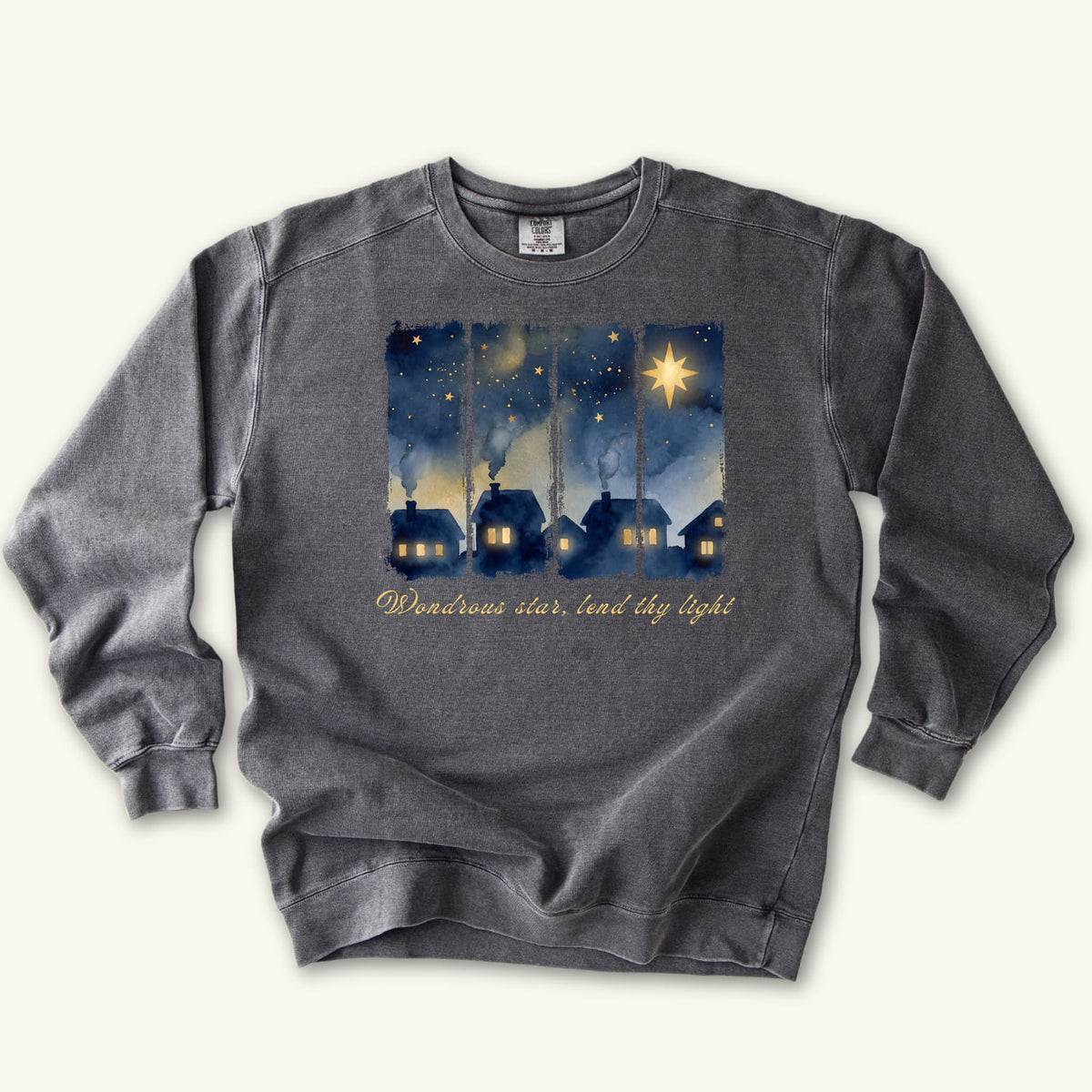 Pepper Christian Christmas sweatshirt with a painted village at night, glowing windows, a big golden star and Wondrous star, lend thy light in script.