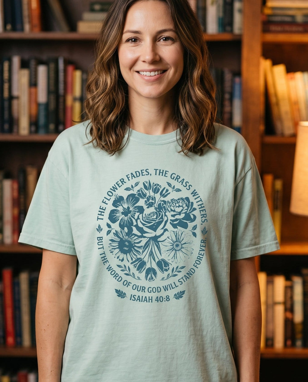 Word of God Stands Forever Isaiah 40:8 Floral - Bay women's Christian tee, lifestyle photo in cozy reading nook - Dense deep-blue woodblock-style bouquet of roses - Isaiah 40:8 - She Wears Faith