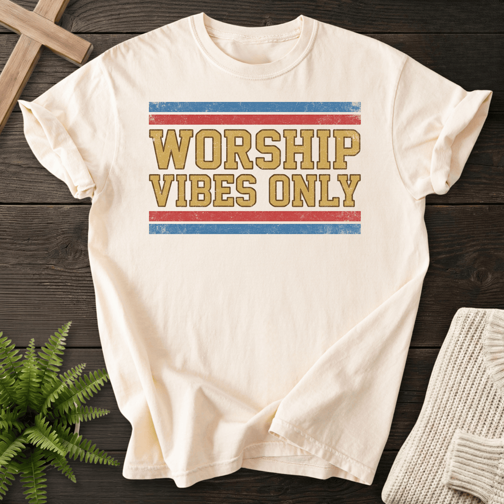 Ivory faith-based tee with retro block Worship Vibes Only lettering in gold and tan.
