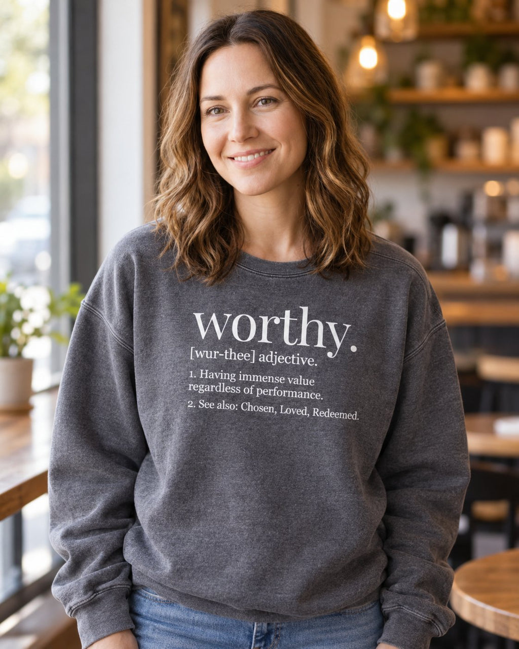 Worthy Definition, Pepper women's Christian sweatshirt, lifestyle photo in cozy cafe, White dictionary style worthy definition, She Wears Faith