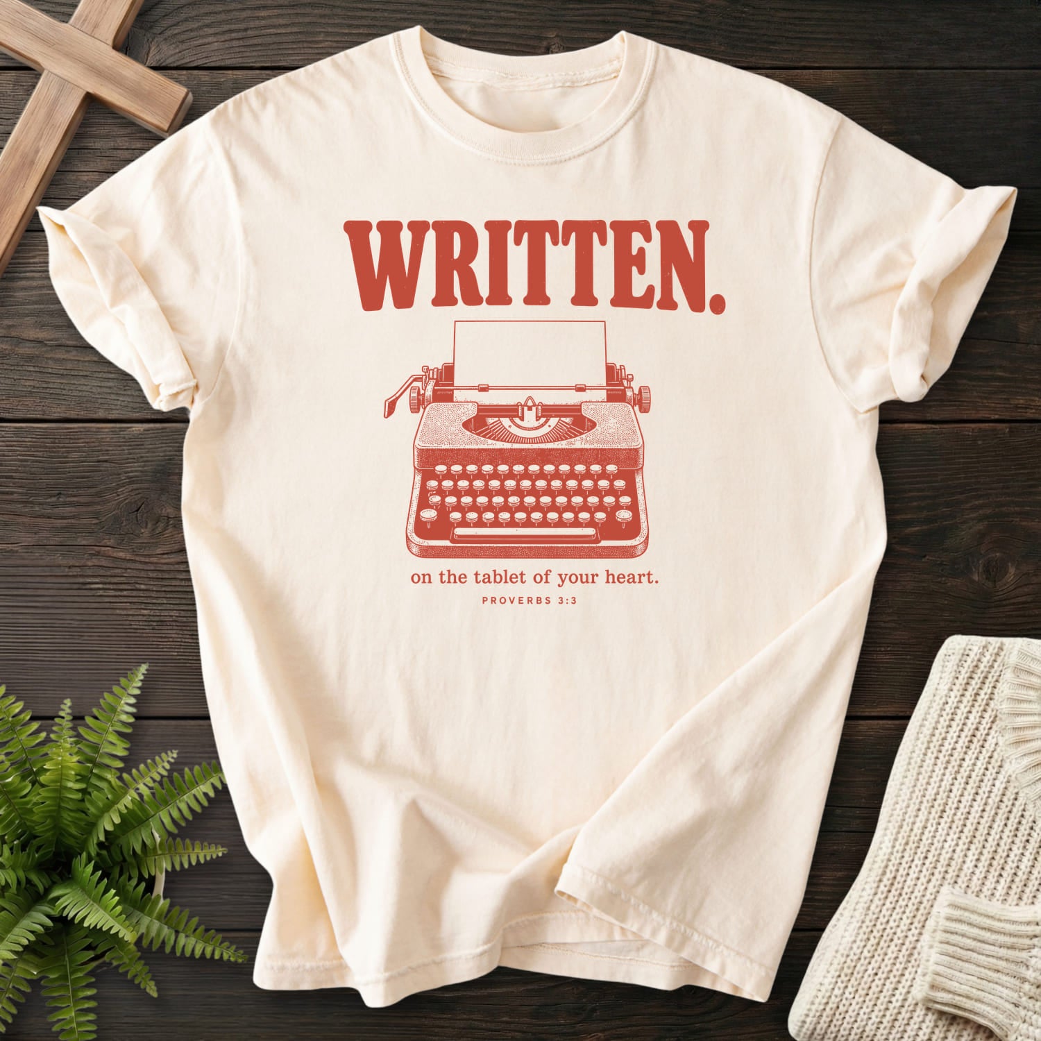 Flat lay of an Ivory Comfort Colors 1717 garment-dyed Christian tee featuring "Written on the Tablet of Your T-Shirt" Proverbs 3:3 From Printify.