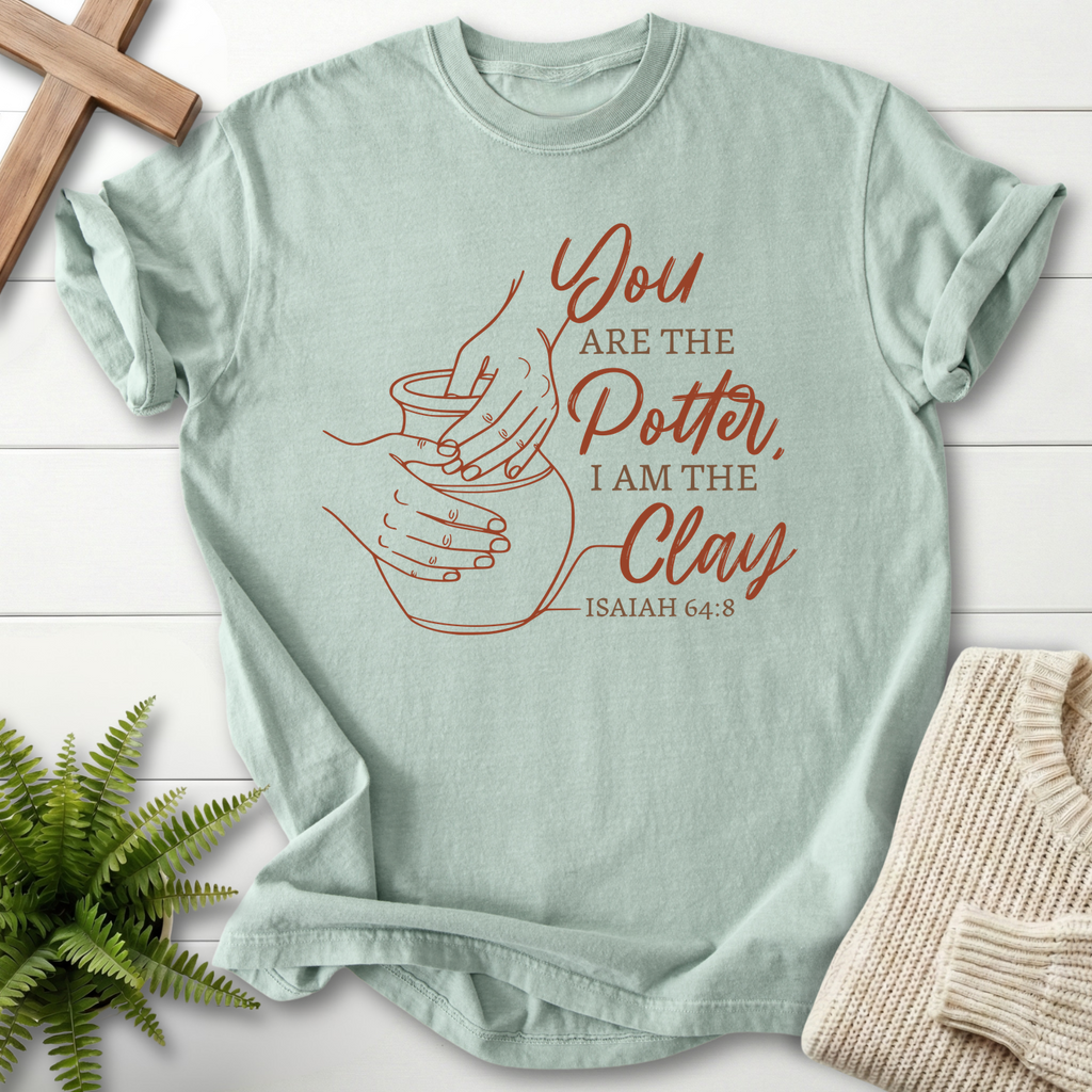 Bay faith-based tee with hands shaping clay illustration, inspired by Isaiah 64:8.