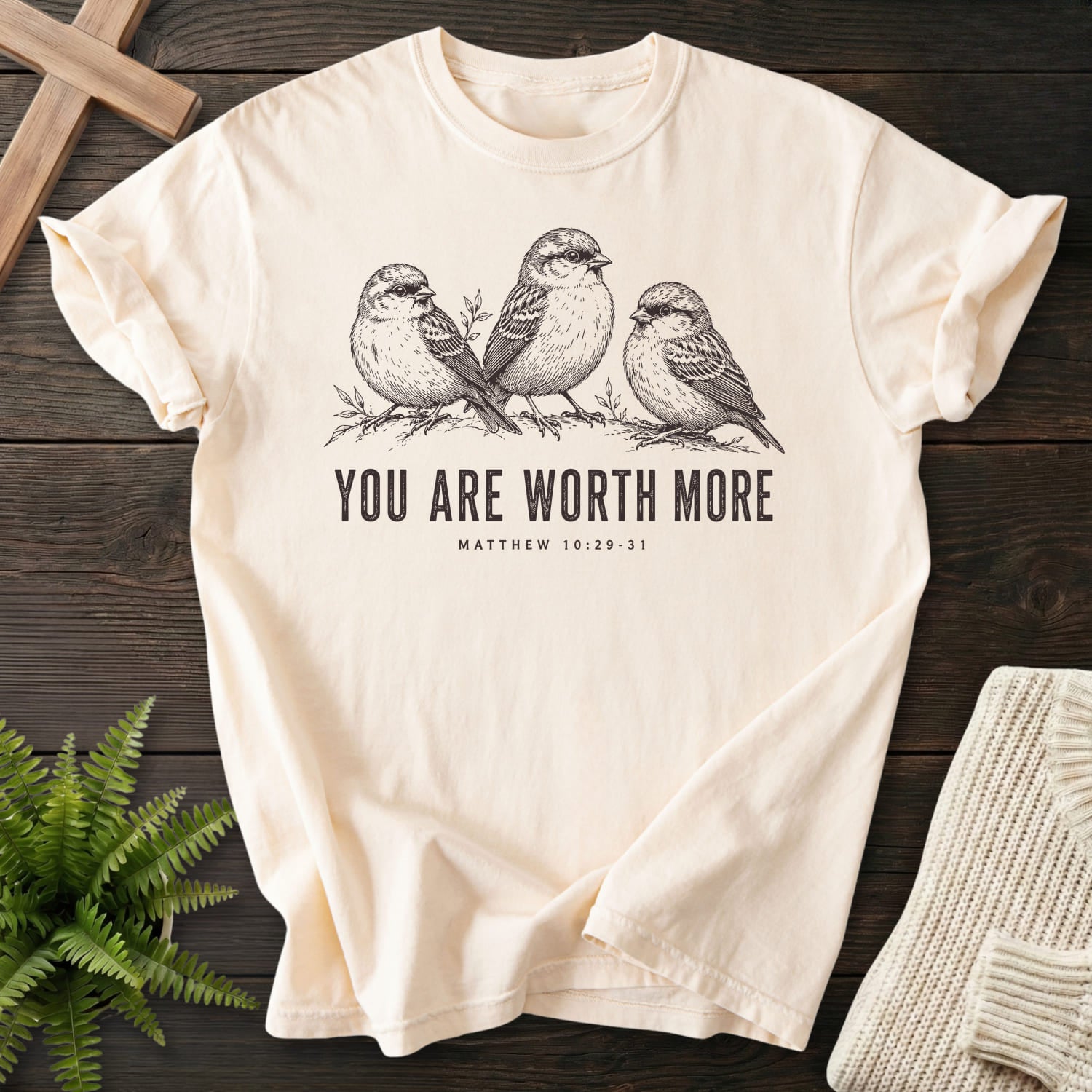Flatlay of an Ivory women's Christian tee with "You Are Worth More Sparrows T-Shirt" design.