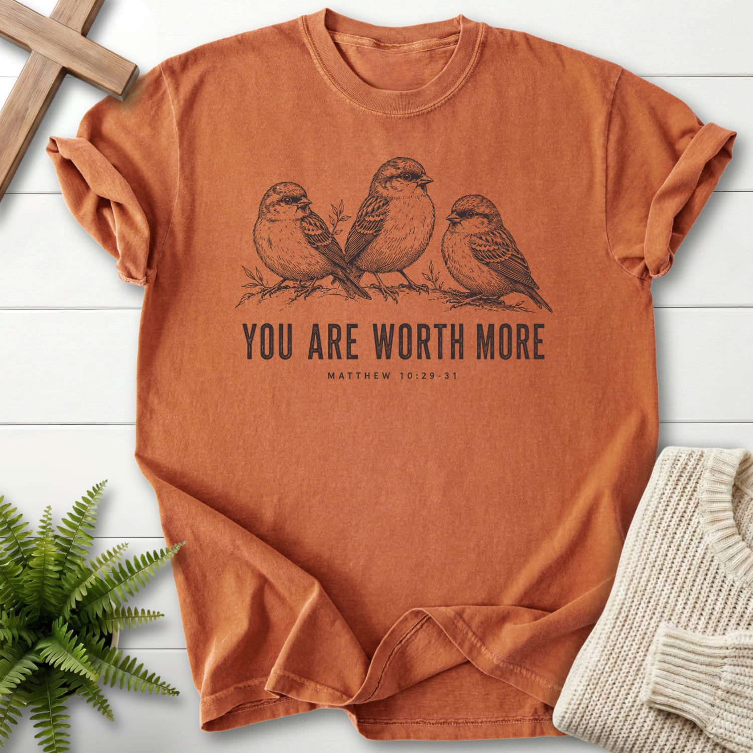 Flat lay of a Yam Christian shirt featuring "You Are Worth More Sparrows T-Shirt" design.